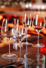 table served with dishes and wine glasses in warm lighting
