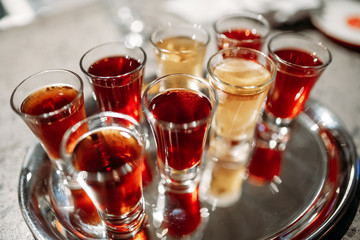 shot glass with a drink on a metal tray