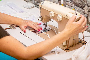 Girl sews masks to protect against the corona virus.