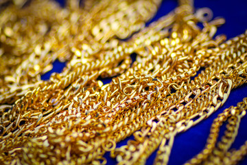 Gold bracelet on blue background