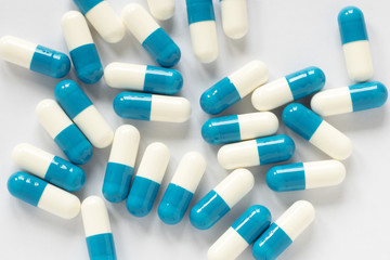 blue-white pills on a plain background