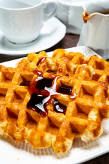 Tasty Belgian dessert, homemade Brussels sugar waffles with dark syrup