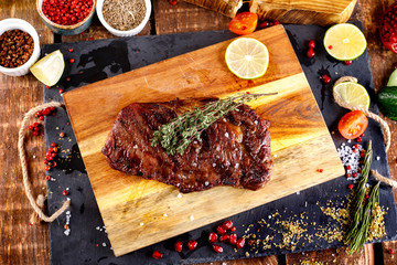 rib eye steak with margarine on a cutting Board
