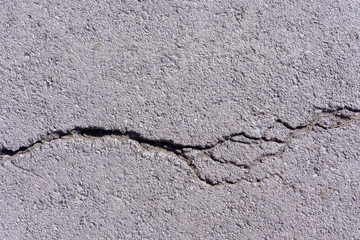 road surface, road patches, cracks in the asphalt. resolution old concrete cement with cracks and natural destruction from time and weather conditions
