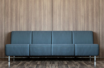 The blue sofa on the center of the room decorated with wall and wood floor