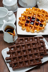 Tasty Belgian dessert, Brussels waffles with chocolade, syrup and white sugar powder