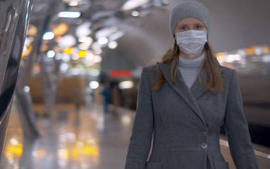 Woman in mask on subway station