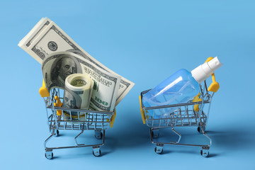 Dollar bills roll in shopping cart and hand sanitizer on shopping. Concept of hoard, buy or...