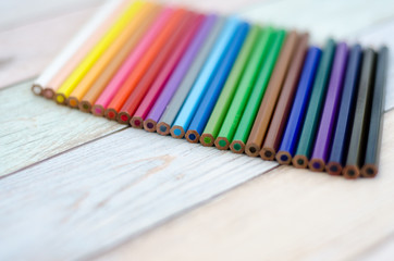 Fototapeta premium colored pencils on wooden background
