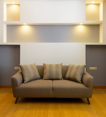 Plush comfortable sofa with decorations in the background 