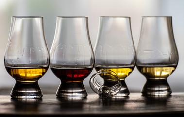 Tasting of flight of Scotch whisky from special tulip-shaped glasses on distillery in Scotland, UK