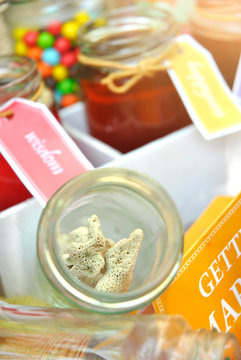 coral in a jar with sweets in the background, pre-wedding photography elements