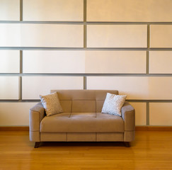 Plush seating arrangement with blank wall shot as a background for artists to insert their art frames to use in advertising. 