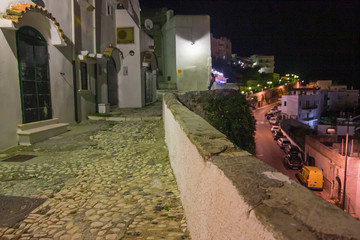 Night view of a picturesque view of the streets of the historic center of the ancient seaside village of the city of Peschici on the Gargano in Italy.