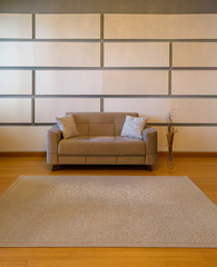 Plush seating arrangement with blank wall shot as a background for artists to insert their art...