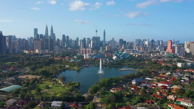 February 23rd, 2020 - Kuala Lumpur, Malaysia : 4k Establishing b-roll aerial shot of drone moving forward towards Kuala Lumpur city skyline. Flying over Titiwangsa Lake. Green and Sustainable City