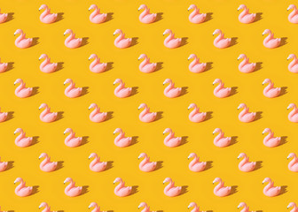 Summer vacation pattern with pink toy flamingo on blue background