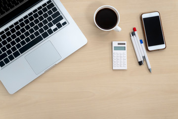 Flat lay home office workspace.Laptop,Coffee cup,Eye glasses, and calculator.