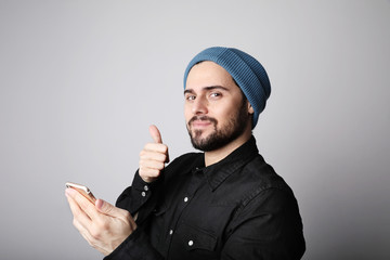 Handsome and bearded hipster wearing stylish hat on head. Brutal man with mustache and beard on...