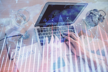 Multi exposure of forex graph with man working on computer on background. Concept of market analysis.