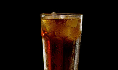 Misted glass of cola turning