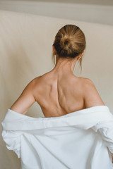 Sensual portrait of a young attractive woman in a white blazer.