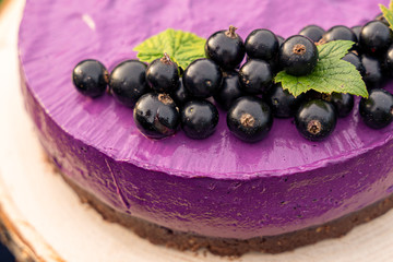  cake with cream and fruits. Black currant cake. Food photo. Berries and flowers. Raw desserts.