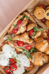 Food delivery box for breakfast. Food delivery from markets and restaurants. Meal for a week on quarantine. Fresh sandwiches, pancakes and eggs at the craft box.