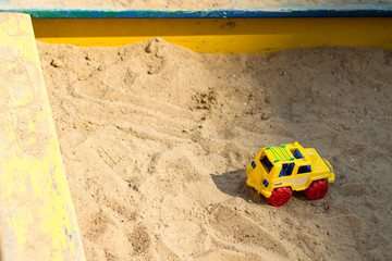 Toy car in the sandbox. Quarantine. Children stayed at home.