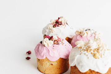 Glazed easter cake decorated with flowers on white textured background. Happy Easter Holidays
