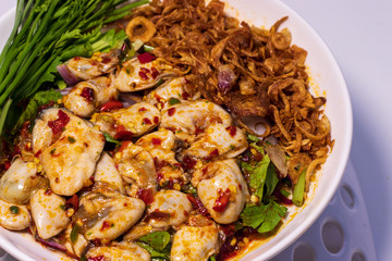 fresh oyster salad hot and spicy seafood in Thai style with fresh vegetable and deep fried onion 