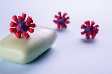 Concept of hand washing, hygiene, for prevention of coronavirus, viruses, to stop spread coronavirus covid 2019. Soap and models of covid-19 virus on blue background