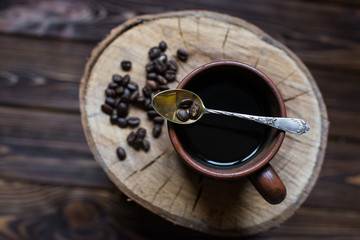 cup of coffee on a wooden background. Coffee, spoon, grain, wooden background.