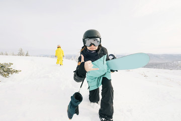 Fototapeta na wymiar Family of snowboarders playing and have fun in snow on mountain top. Sunny holiday in ski resort