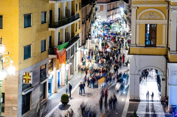 Long Exposure Street Photo. Ghosts of people walking in Corso Garibaldi in Benevento at night. Campania, Italy
