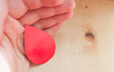 World Blood Donor Day. World Hemophilia Day. Hand holds a drop of blood. World Hemophilia Day....
