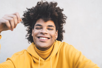 Afro smiling man portrait - Mixed race young guy having fun posing in front camera - Youth millennial generation culture and multiracial people concept - obrazy, fototapety, plakaty