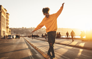 Afro American man having fun walking in city center - Happy young guy enjoying time a sunset...