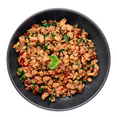 Pad Krapow Gai - Thai Basil Chicken in black bowl isolated on white background. Pad Krapow is Thai cuisine dish with minced chicken or pork meat, basil, soy and oyster sauces. Thai Food