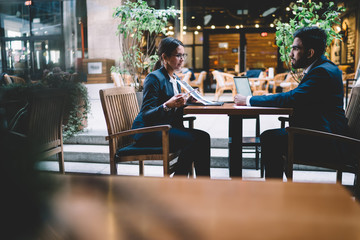 Colleagues working in lobby of modern hotel