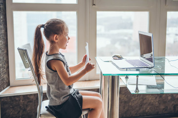 School girl  is studying online. Home schooling. Distance education.