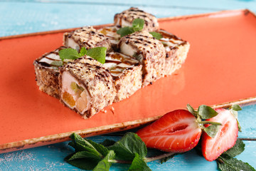 Dessert Maki sushi roll with various fruits and cream cheese inside.