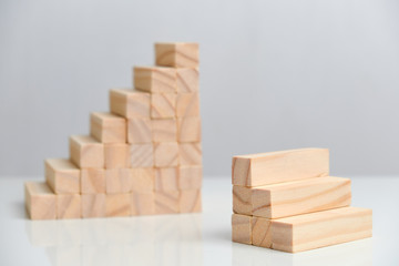 The concept of comparing small and medium-sized businesses. Wooden blocks on a white background background.