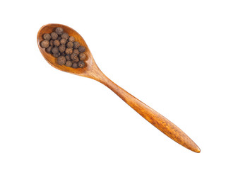 Spice allspice in wooden spoon isolated on white