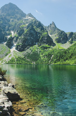 The lake Morskie Oko or Eye of the Sea. Western Carpathian mountains. The Tatra National Park in the Rybi Potok (the Fish Brook) Valley, Zakopane, Poland. - obrazy, fototapety, plakaty