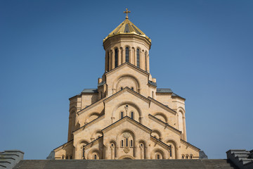 Fototapeta na wymiar Front view of Holy Trinity Cathedral of Tbilisi also known as Tsminda Sameba, orthodox church in sunny day, Georgia
