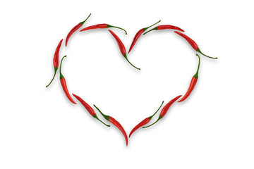 Heart shaped frame made of red chili peppers on a white background