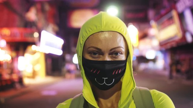 Woman close up look caucasian at Pattaya Walking Street with wearing protective medical mask. Lockdown quarantine isolation. Health virus protection coronavirus epidemic sars-cov-2 covid-19 2019-ncov.