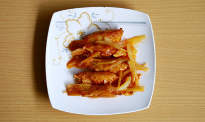 Sweet and Sour salmon fin on white plate. Indonesian food.