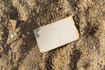 Alte leere Seite aus einem Buch liegt auf Sand